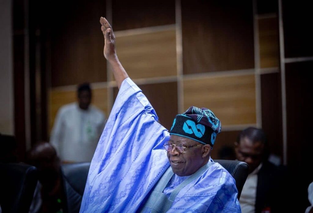 Bola Tinubu smiling and waving his hand